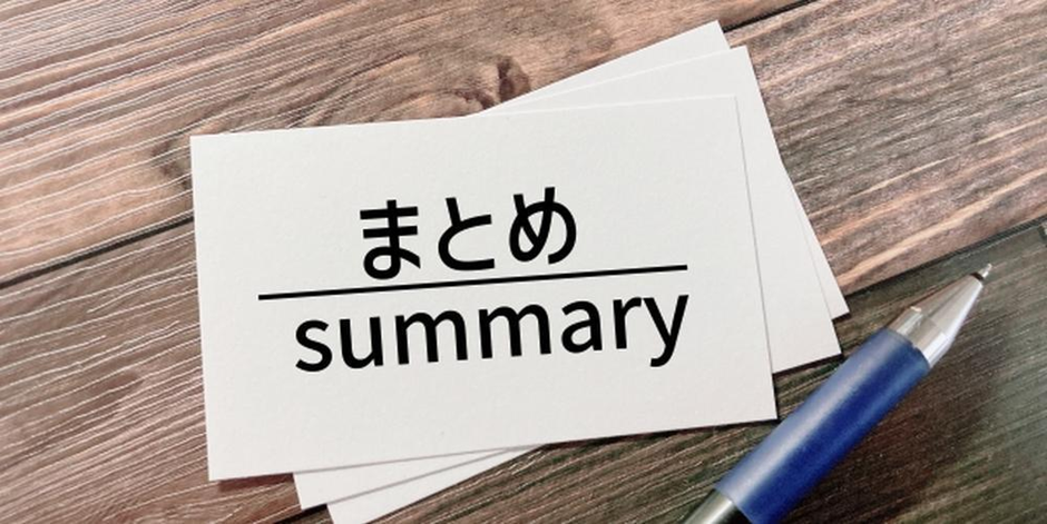木目のテーブル上に置かれた「まとめ summary」と書かれたカードとボールペンの画像