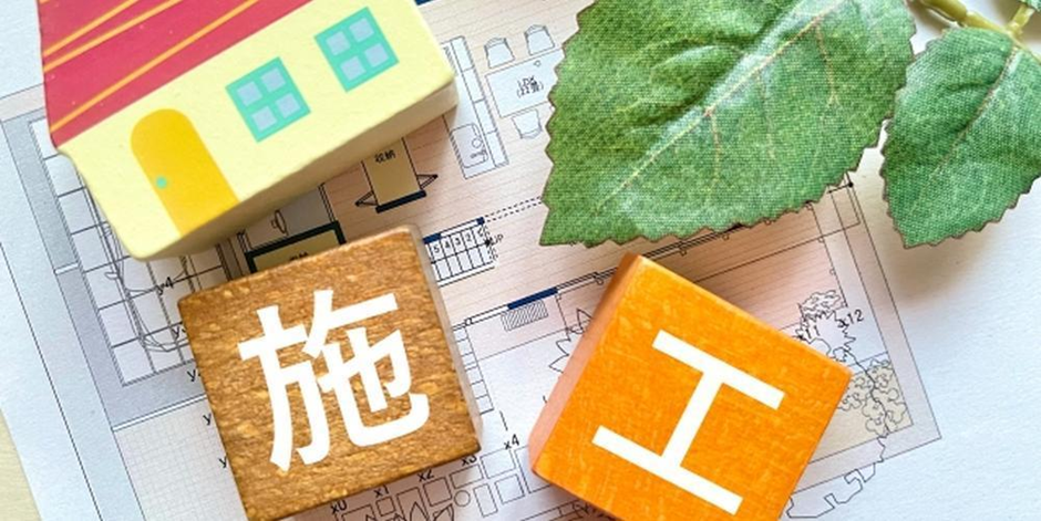 住宅の設計図と積み木で表現された施工のイメージ